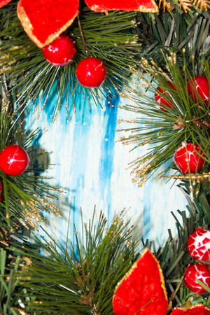 Christmas border from christmas wreath useful as christmas decoration. Christmas Greeting Card. Vintage Style. Hanging christmas decoration on wooden background.の写真素材