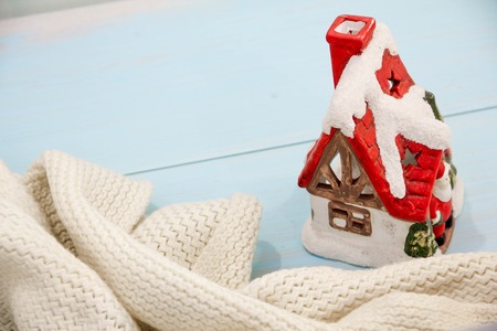 Christmas decorations concept of preparing turquoise shabby wooden table. cozy knitted blanket and cabin concept winter holiday. place text flat lay with copy space slogan or messageの写真素材