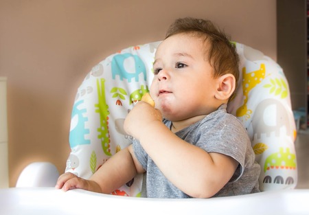 Kid eats on a white background.の写真素材