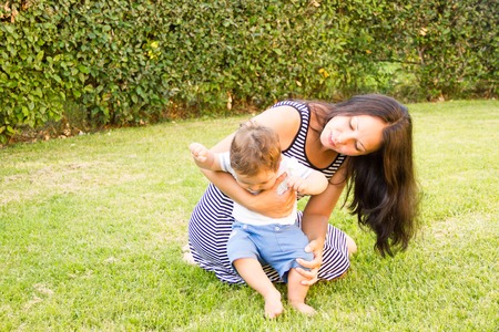 Portrait of happy loving mother and her baby outdoorsの写真素材