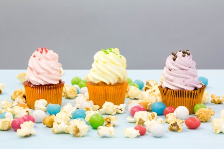 Cake, candies, marshmallows, cakepops, fruits and other sweets on dessert table at kids birthday partyの写真素材
