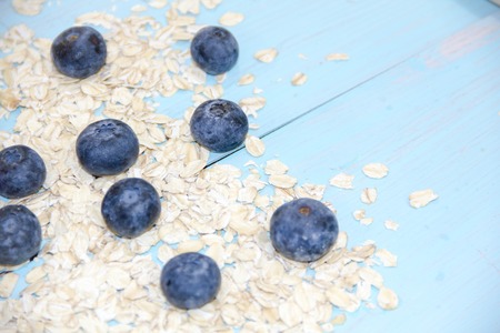 Healthy breakfast Fresh granola, muesli in bowl with milk and berries on a white backgroundの写真素材