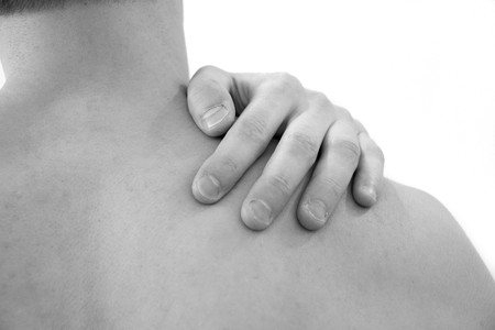 Pain in the shoulder. Man with backache. Muscular male body. Isolated on white background with red dot. healthcare and problem concept unhappy man suffering from neck or shoulder pain at homeの写真素材