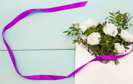 Fresh pink flowers hyacinths in ray of light on turquoise painted wooden planks. Selective focus. Place for text.の写真素材