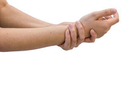 unhappy woman suffering from pain in hand at homeの写真素材