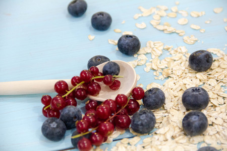 Healthy breakfast Fresh granola, muesli in bowl with milk and berries on white backgroundの写真素材