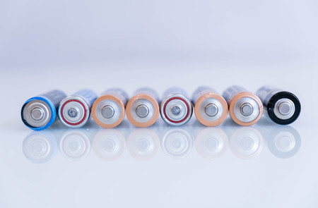 old battery was leaking, hazardous waste. abstract background of colorful batteries. . Alkaline battery aa size. Group of used disposable drain batteries of various size ready for recycling.の写真素材
