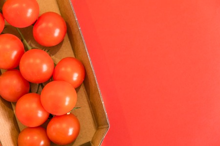 Seamless pattern with cherry tomatoes. Abstract background. Tomato on the red background. Group of red ripe tomatoes cooking concept. Top view with copy spaceの写真素材