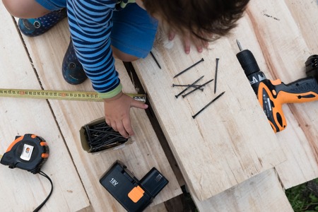 kids playing with craftsman toolsの写真素材