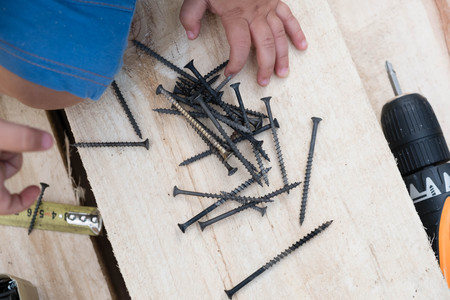 kids playing with craftsman toolsの写真素材