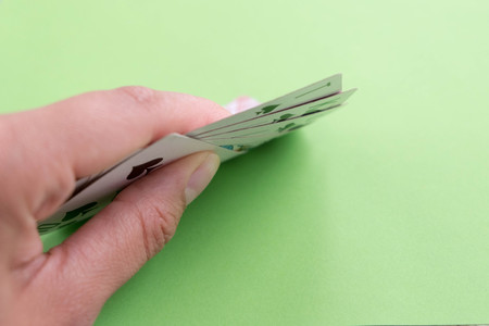 playing cards in a people hand. Close-up of a poker player holding playing cardsの写真素材