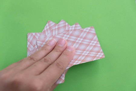 playing cards in a people hand. Close-up of a poker player holding playing cardsの写真素材