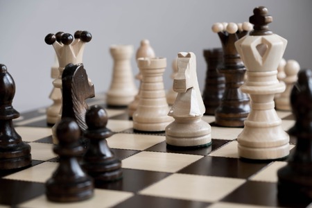 Wood chess piece knight on chessboard with Blurred image and vintage color tone process , Competition success and strategy game play.の写真素材