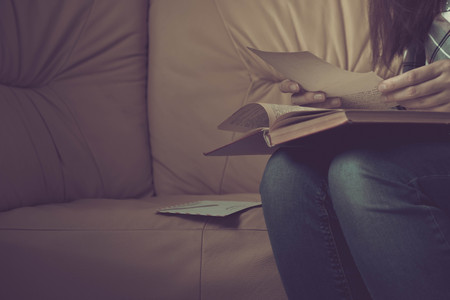 A girl holding a stack of old letters.の写真素材