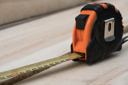 tape measure on the brown wooden background