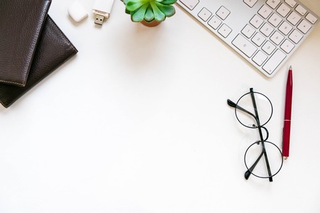Modern white office desk table with laptop computer, Stylish tablet with black screen over. Minimal concept. Top view with copy space, flat lay. workspace creative designerの写真素材
