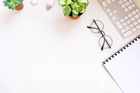 Modern white office desk table with laptop computer, Stylish tablet with black screen over. Minimal concept. Top view with copy space, flat lay. workspace creative designerの写真素材