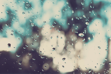 Rain on a Window. Rain on a window blurs the outside to an out of focus pattern.の写真素材