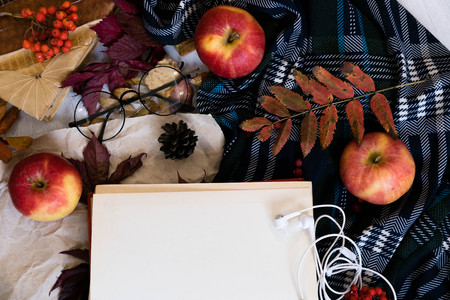 Old book,smart phone , autumn leaves on wooden background. Concept autumn. Top viewの写真素材