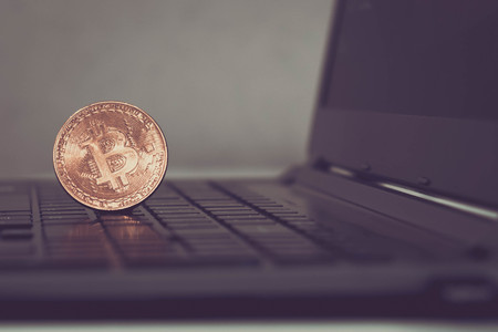 Golden Bitcoins on laptop. Photo new virtual moneyの写真素材
