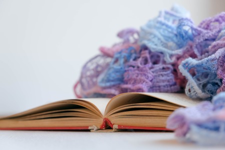 Cozy winter still life: opened book. Warm and comfy autumn or winter concept. sweater. Reading relaxing cold fall weather at home. Winter holidays, Christmas time concept, free copy spaceの写真素材
