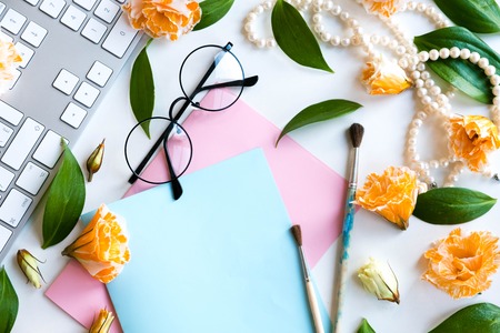 Flat lay, top view office table desk. Notes of creative worker scattered on table. Work place of a creative person with a variety of colorful stationery objectsの写真素材