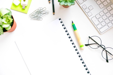 Modern white office desk table with laptop computer, Stylish tablet with black screen over. Minimal concept. Top view with copy space, flat lay. workspace creative designerの写真素材