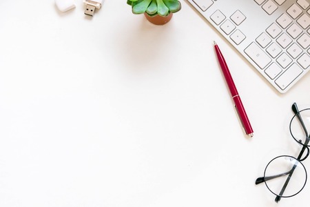 Modern white office desk table with laptop computer, Stylish tablet with black screen over. Minimal concept. Top view with copy space, flat lay. workspace creative designerの写真素材
