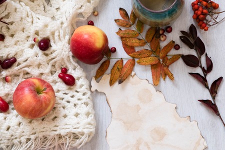 Fresh Pastry Bun, Cup of hot coffee and autumn leaves on wooden background. Wooden letters word AUTUMN. Top view, copy space.の写真素材