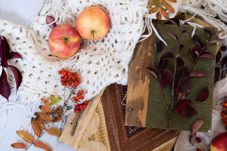 Old book,smart phone , autumn leaves on wooden background. Concept autumn. Top view