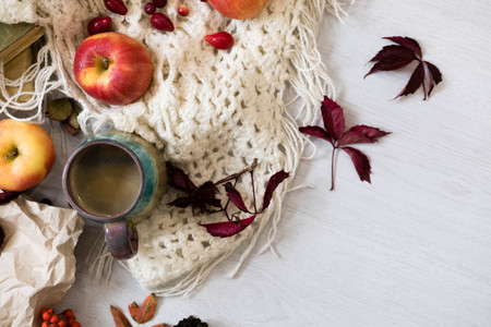 Fresh Pastry Bun, Cup of hot coffee and autumn leaves on wooden background. Wooden letters word AUTUMN. Top view, copy space.の写真素材
