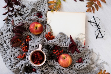 Old book,smart phone , autumn leaves on wooden background. Concept autumn. Top viewの写真素材