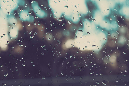 Rain on a Window. Rain on a window blurs the outside to an out of focus pattern.の写真素材