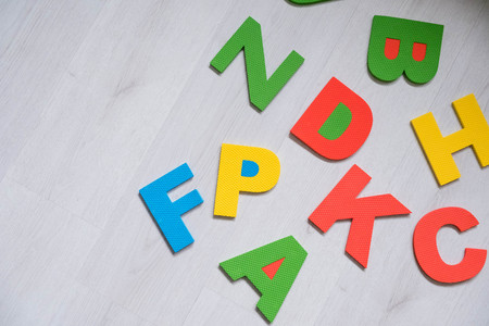 Colorful letters on background closeup A close up shot of ABC. Educational abc toys for kids. Preschool education. English alphabet randomly scattered on a gray background. Latin letters. Color lettersの写真素材