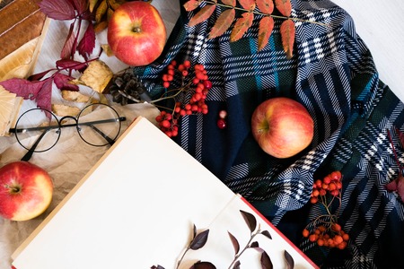 Old book,smart phone , autumn leaves on wooden background. Concept autumn. Top viewの写真素材