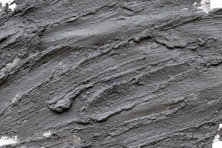Black volcanic cosmetic clay texture close up. solution of cosmetic clay abstract background.