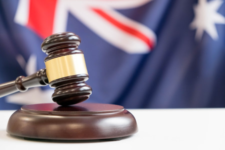 Gavel and legal book on wooden table, collage with flag of australiaの写真素材