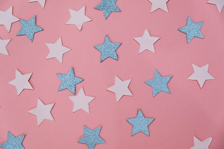 star sprinkles on pink. Festive holiday background. Celebration concept. Top view, flat lay. Horizontalの写真素材