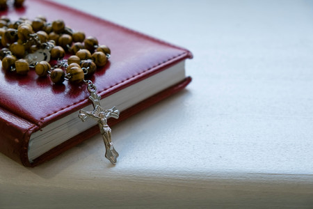 Closeup crucifix, Holy Bible and vintage rosary beads. Religion concept retro vintage color effectの写真素材