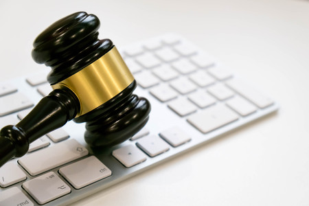 Top view, flat lay. Close up on a white background. copy space for text, selective focus. justice and law concept.Lawyer workplace with laptop and documents with dark woodenの写真素材