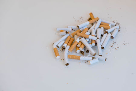 broken scattered cigarettes, tobacco, close-up on a black background. Top view with copy space, flat lay. STOP Smoking. World no tobacco day.の写真素材