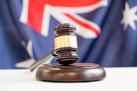 Gavel and legal book on wooden table, collage with flag of australiaの写真素材