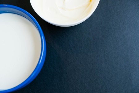 White bowl of cream on light blue background, top viewの写真素材