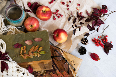 Mug of black coffee wrapped in warm scarf on wooden board. Top view, vintage style, Still life.の写真素材
