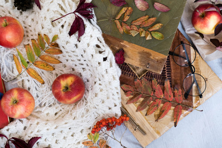 Mug of black coffee wrapped in warm scarf on wooden board. Top view, vintage style, Still life.の写真素材