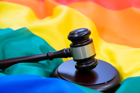 Hammer and gavel against against rainbow flag. gay flag backgroundの写真素材