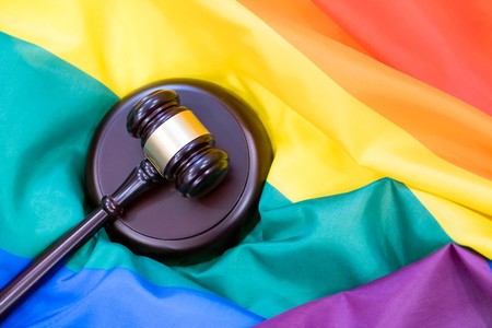 Hammer and gavel against against rainbow flag. gay flag backgroundの写真素材