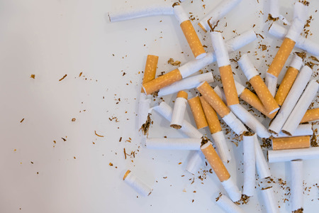 broken scattered cigarettes, tobacco, close-up on a black background. Top view with copy space, flat lay. STOP Smoking. World no tobacco day.の写真素材