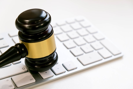 Top view, flat lay. Close up on a white background. copy space for text, selective focus. justice and law concept.Lawyer workplace with laptop and documents with dark woodenの写真素材
