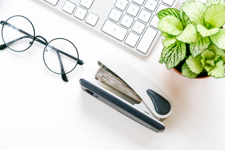 Flat lay, top view office table desk frame. feminine desk workspace with laptop, diary, succulent, glasses, watch on white background.の写真素材